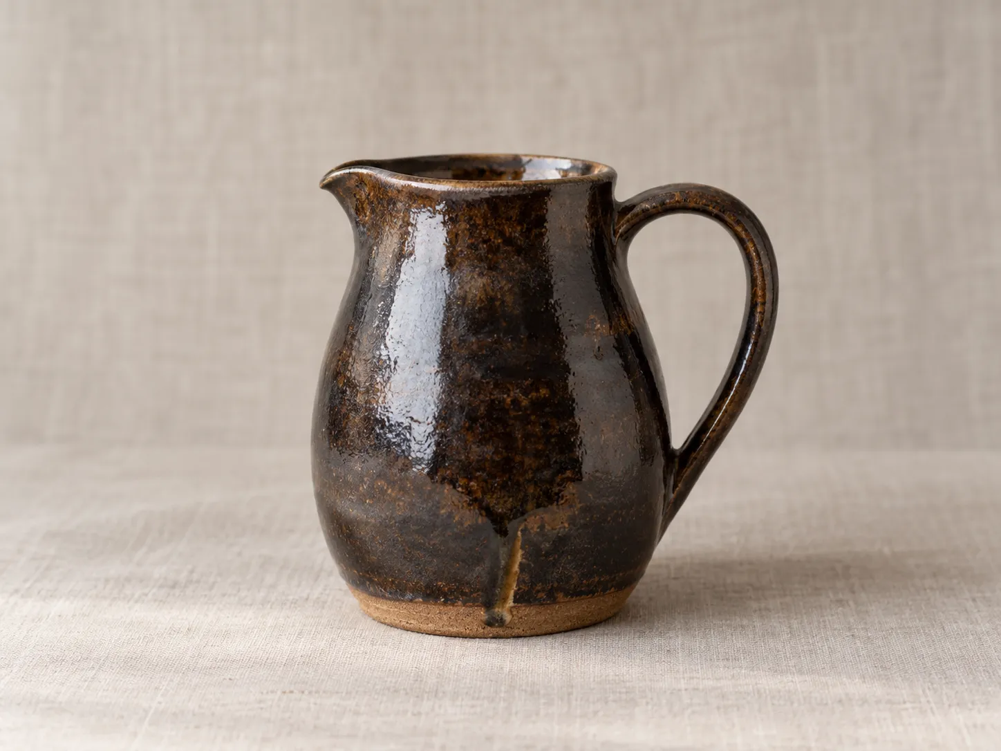 A dark tenmoku stoneware jug.
